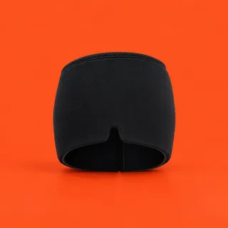 AcheSoothe, the black fabric cap with a notch in its lower edge, on a vermilion background