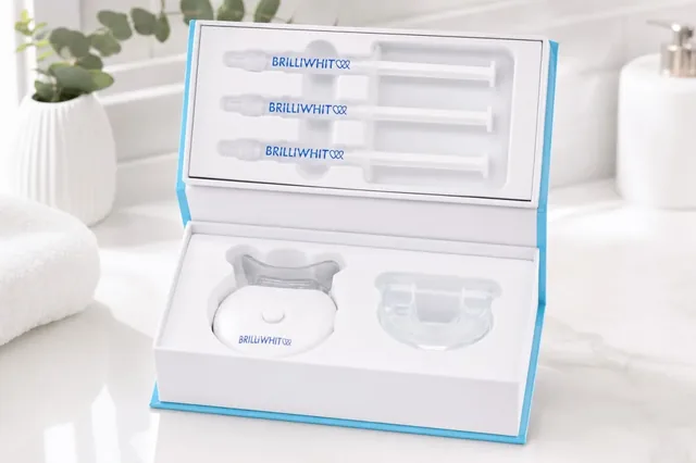 The open BrilliWhite kit on a bathroom counter: three gel syringes in the lid, the LED unit and the clear mouthpiece in the base