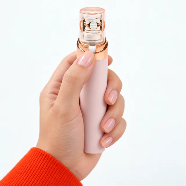 A hand holding the EpiGlow upright, the thumb at the small switch just below its clear cap