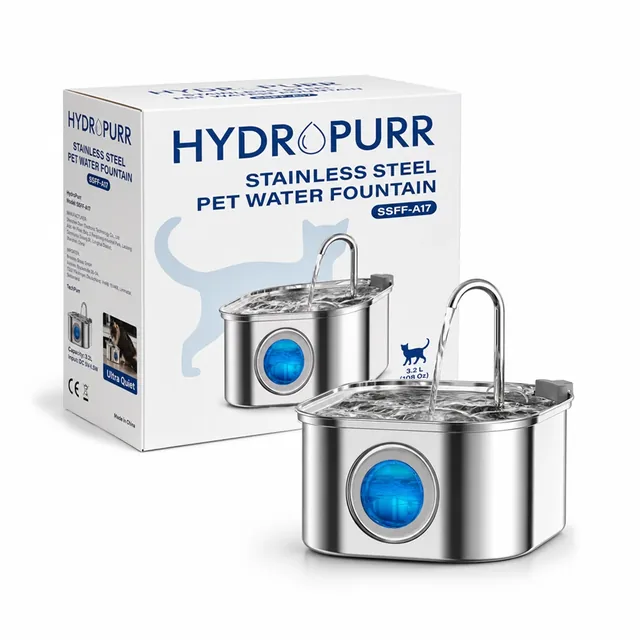 The brushed stainless steel HydroPurr fountain, water pouring from its curved spout, in front of its white box printed HYDROPURR, STAINLESS STEEL PET WATER FOUNTAIN and SSFF-A17, on white