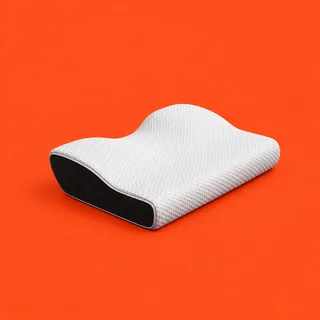 Memvra, the contoured white pillow with its black mesh side, on a vermilion background