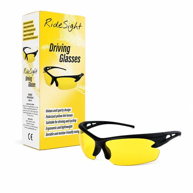 The RideSight glasses lying in front of their tall yellow box on white, the box printed RideSight and Driving Glasses