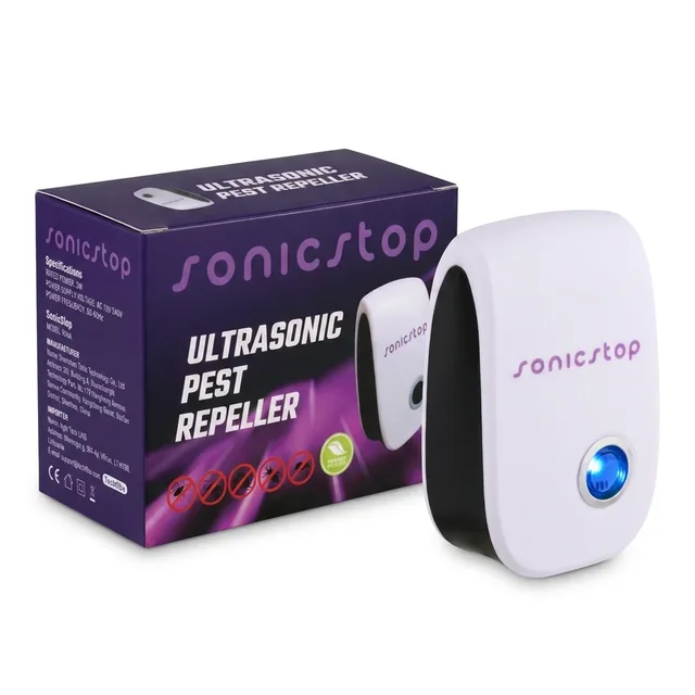 The white SonicStop plug in repeller with its round blue light, standing in front of its purple box, on white